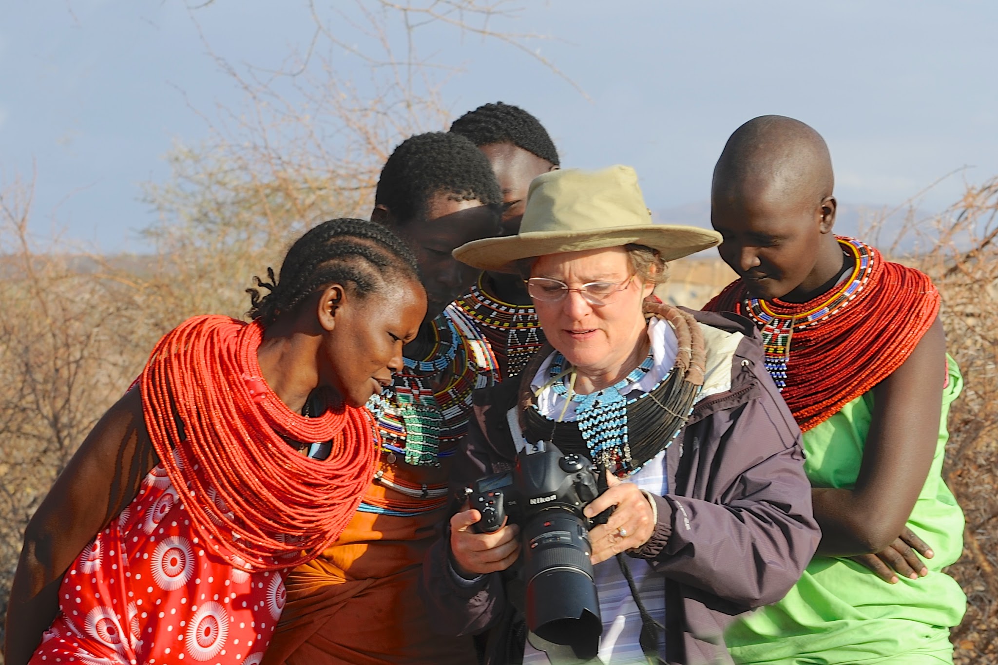 The Old Bat Showing Zebra Pictures to the Beautiful Samburu Women